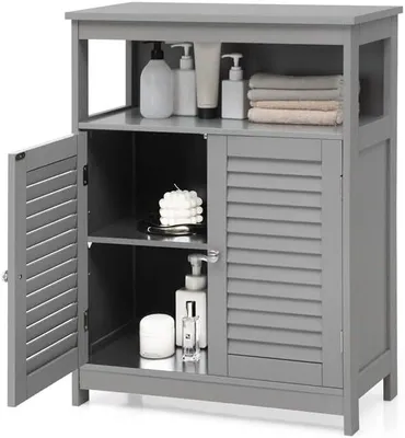 A gray bathroom storage cabinet with its left door open, displaying shelves and items like bottles, a candle, and towels.