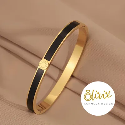 Produktbild von XCOAST Armreif aus Edelstahl – goldfarben mit schwarzen Akzenten, öffn- und schließbar - perfektes Valentinstagsgeschenk