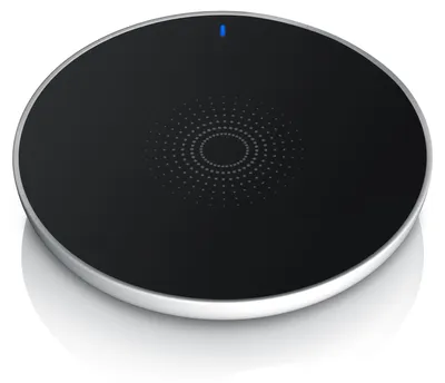 A round, black wireless charger with a silver rim, shown from a slightly elevated angle on a white background.