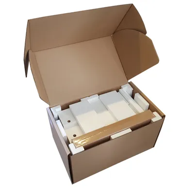 An open cardboard box containing packaging material and what appears to be a disassembled product.