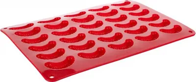 A red silicone mold with 30 individual cavities shaped like worms or gummy candies.