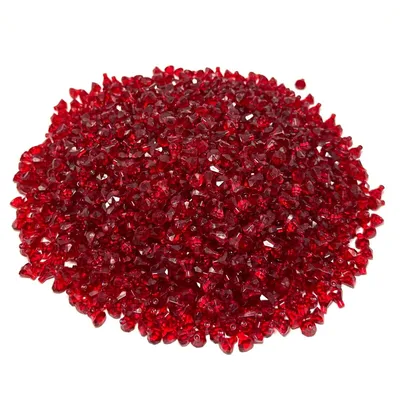 A pile of red, faceted gemstones on a white background.