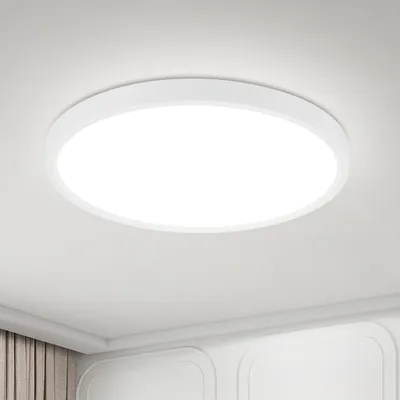 A white, circular LED ceiling light is mounted on a white ceiling.