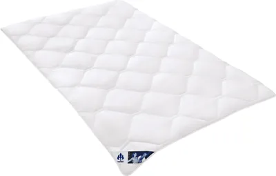 A white quilted duvet is shown laid out diagonally on a white background.