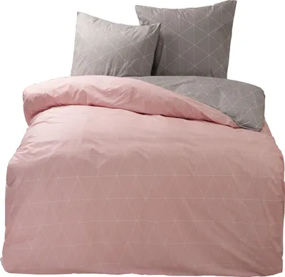 A bedding set with a pink duvet cover and gray pillowcases, both featuring a geometric triangle pattern.