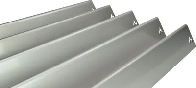A close-up, angled view of several metal heat plates for a grill.