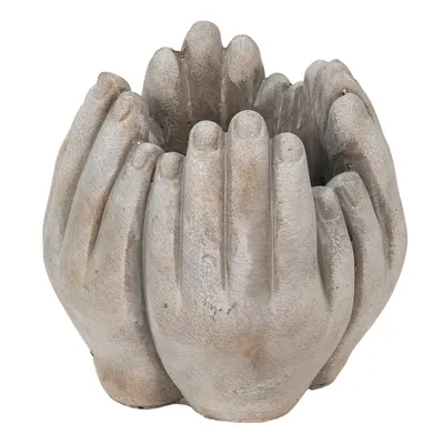A beige stone planter shaped like cupped hands.