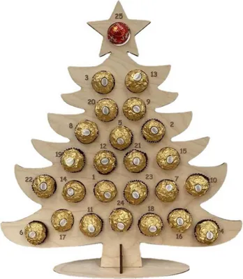 A wooden advent calendar shaped like a Christmas tree, filled with chocolates.