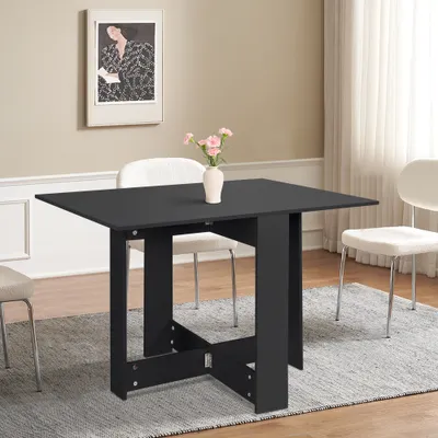 A black folding table with a vase of flowers on top, set in a dining room with chairs and a painting on the wall.