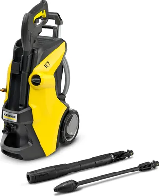 A yellow and black Kärcher pressure washer with two attachments in the foreground, set against a white background.