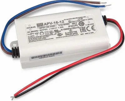 A white LED power supply unit with wires attached, lying on a white surface.