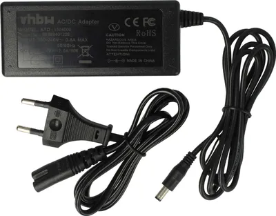 A black AC/DC adapter with attached cables and plugs, laid out on a white background.