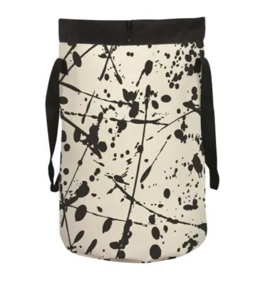 A laundry bag with a black and white splatter pattern.