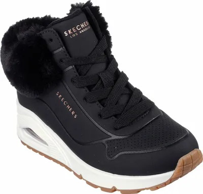 A black Skechers sneaker with faux fur trim is shown against a white background.