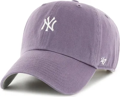 A close-up studio shot of a purple New York Yankees baseball cap.