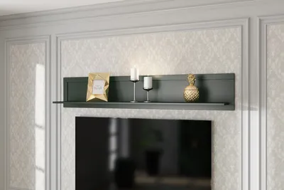 A shelf with decorative items above a television.