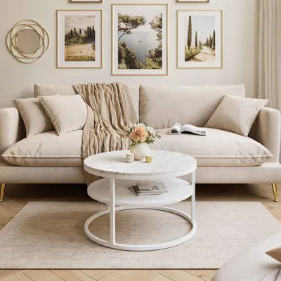 A living room scene featuring a beige sofa, coffee table, and artwork.