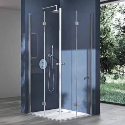 A modern corner shower cabin with glass doors and chrome fixtures, set against a dark blue wall with a window showing a green, leafy outdoor scene.