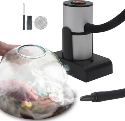 A portable food smoker is shown with a glass dome filled with smoke, infusing food with flavor. Accessories for the smoker are also visible.