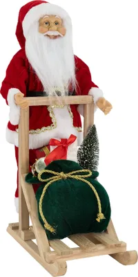 Imagen del producto de ECD Germany, figura decorativa de Papá Noel, 30x20x50 cm, fabricada en poliresina y madera. Adorno navideño que representa a Papá Noel de pie sobre un trineo. Decoración navideña, decoración de invierno, Santa Claus, San Nicolás