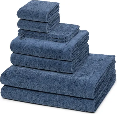 A stack of folded blue towels of varying sizes.