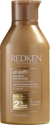 A bottle of Redken All Soft Shampoo.