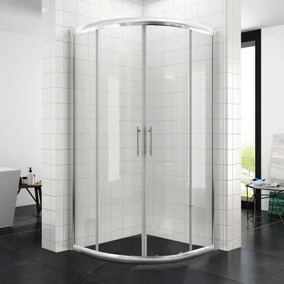 A modern shower enclosure in a bathroom setting with white tiled walls and black tiled floor.