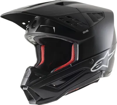 A black motocross helmet with red interior padding, shown from a three-quarter angle against a white background.