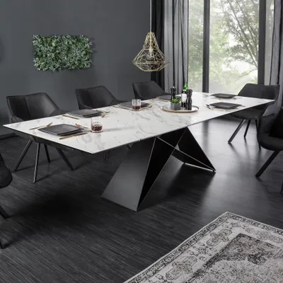A dining room scene with a modern marble-top dining table and chairs.