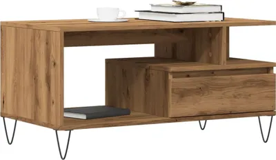 A modern wooden coffee table with a drawer and open shelving, resting on black hairpin legs.