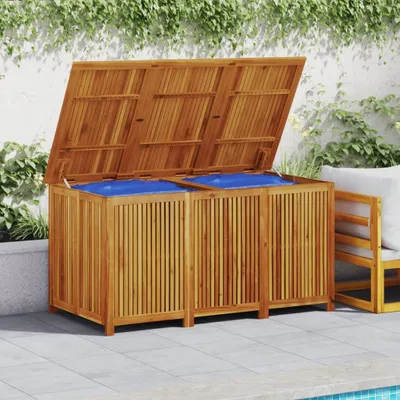 A wooden storage box with blue liners is shown outdoors on a patio next to a pool.