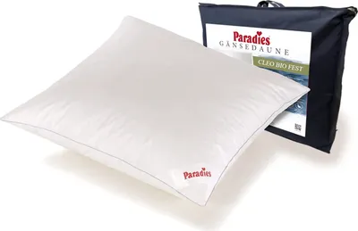 A white pillow is shown in front of a dark blue bag with product information.