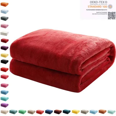 A folded red blanket is shown on a white background, with a row of color swatches to the left and a certification logo in the top right corner.