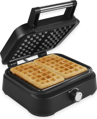 A black waffle maker with two waffles inside, shown from a slightly elevated angle.