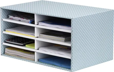 A desk organizer with multiple compartments filled with papers and a calculator.