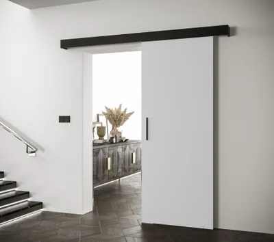 A white sliding door with a black handle is partially open, revealing a hallway with a wooden cabinet and stairs.