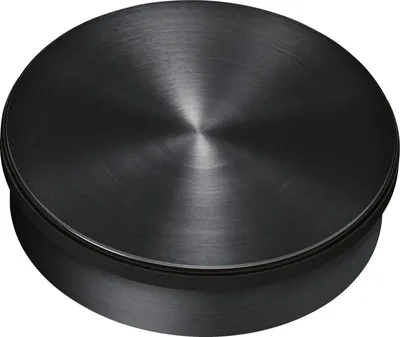 A close-up, top-down view of a black, circular knob with a brushed metal finish.