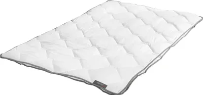 A white quilted comforter with a gray trim is shown on a white background.