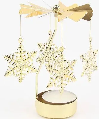 A golden snowflake-shaped Christmas pyramid with a candle holder at the base.