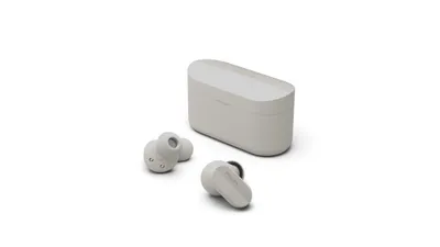 A pair of white in-ear headphones and their charging case are displayed on a white background.