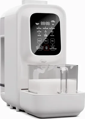 A white kitchen appliance with a digital display and a clear container filled with a white liquid.