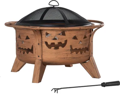 A Halloween-themed fire pit with a jack-o'-lantern design, shown on a white background with a poker tool.