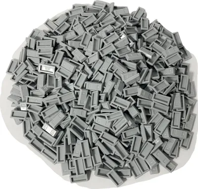 A pile of small, rectangular gray LEGO tiles.