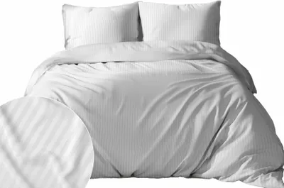 A white satin striped duvet cover and two pillowcases are neatly arranged on a bed.