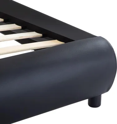 A close-up view of the corner of a black bed frame with wooden slats.