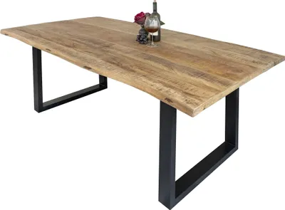 A wooden dining table with black metal legs, set against a white background. A bottle of wine and a glass are placed on the table.