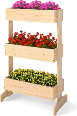 A three-tiered wooden planter with pink, red, and yellow flowers.