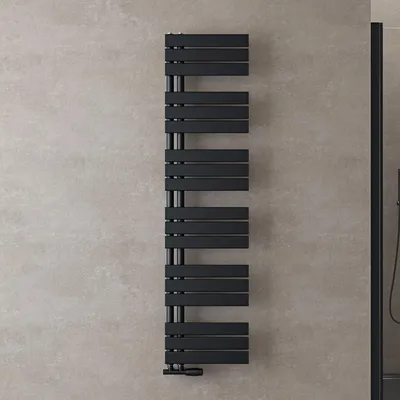 A black radiator mounted on a textured gray wall.