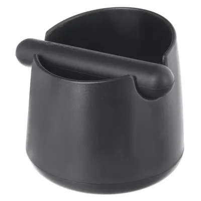 A black coffee knock box with a tamper resting on top, isolated on a white background.