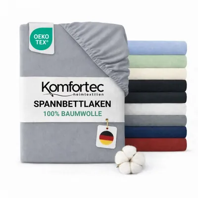 A folded fitted sheet is shown prominently, with a stack of other fitted sheets in various colors in the background.